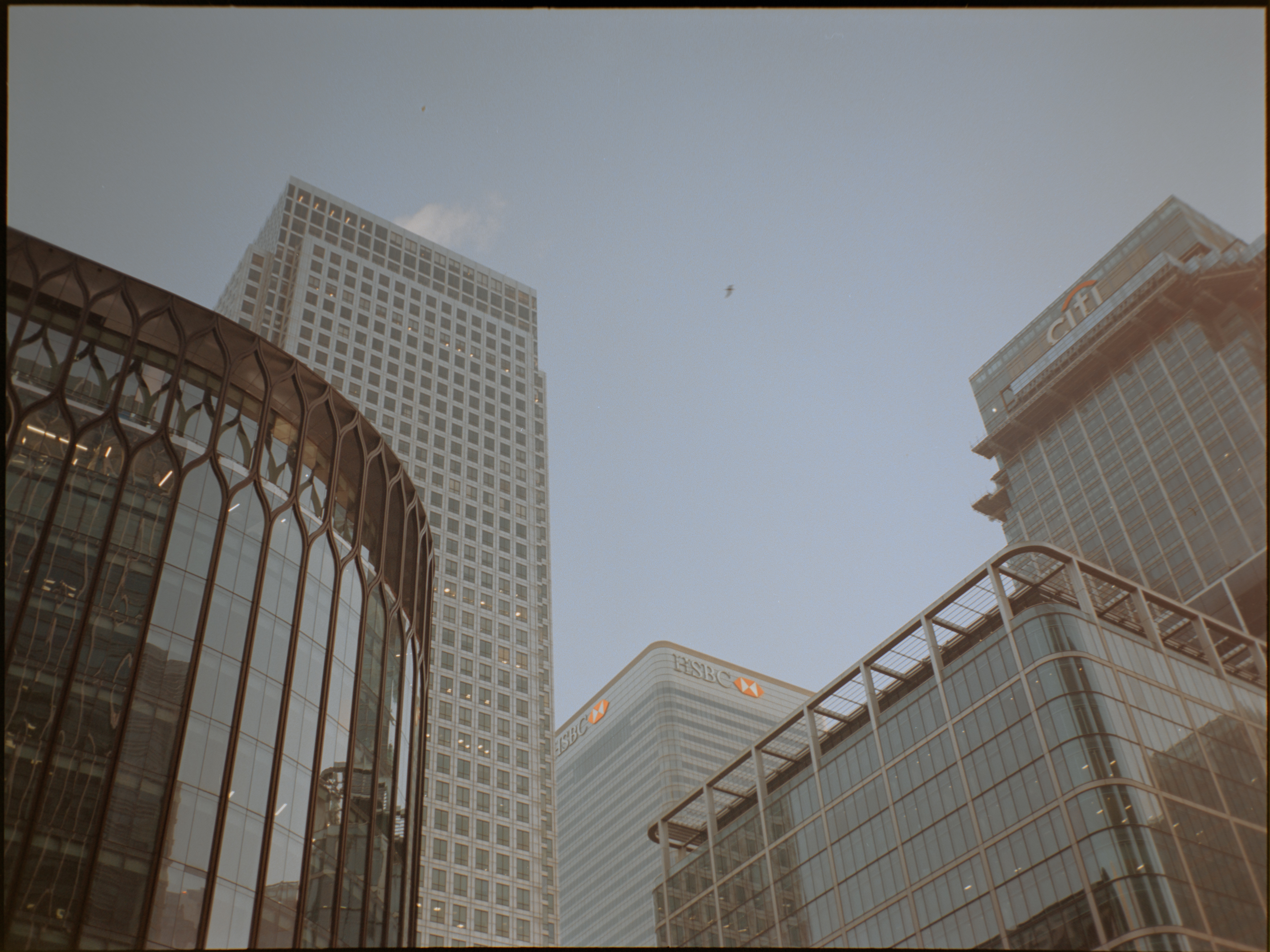 Modern glass skyscraper looking upward in Canary Wharf — Fujifilm GA645S on Kodak Portra 160