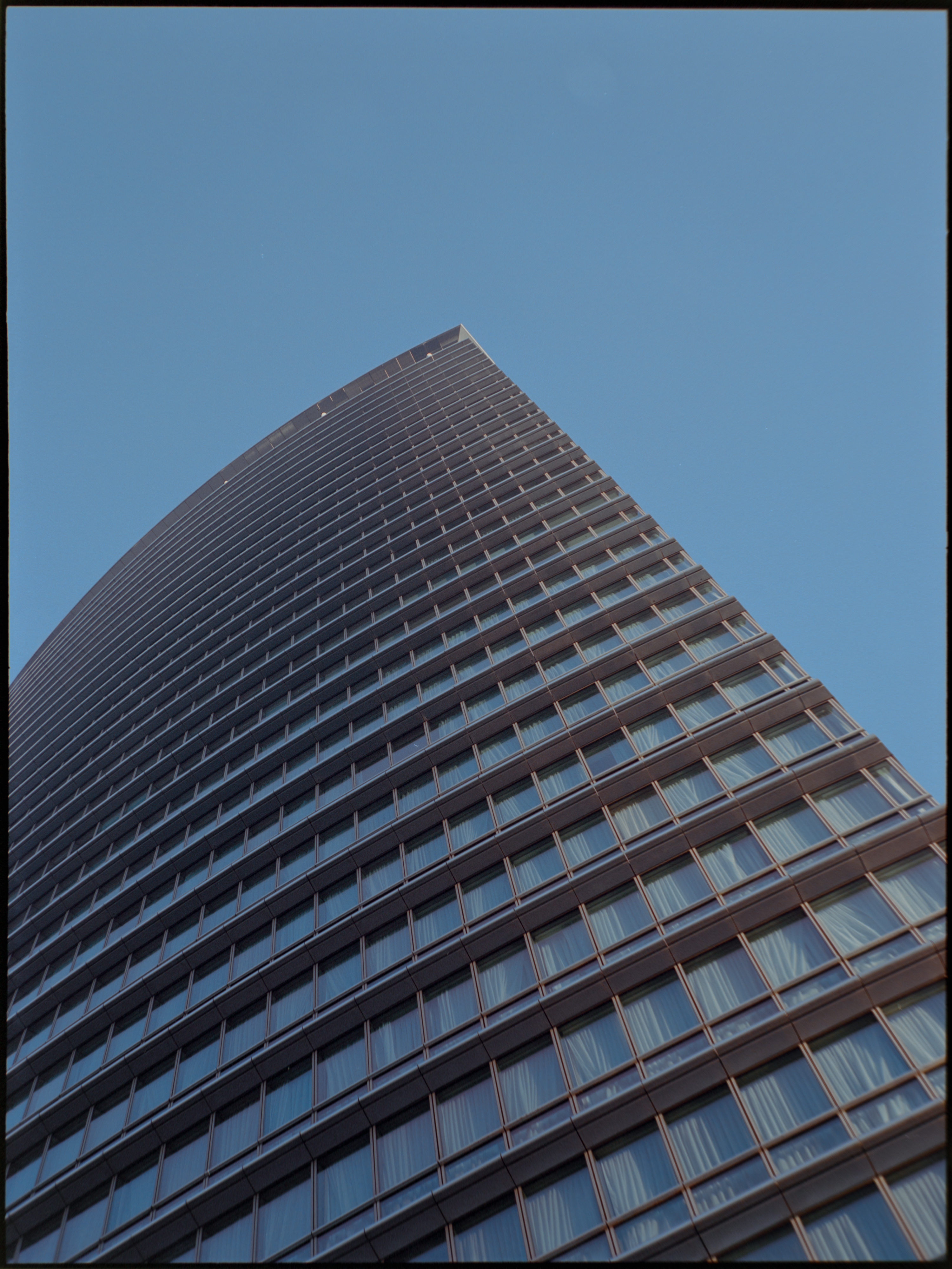 Architectural detail of modern glass and steel building in Canary Wharf — medium format film