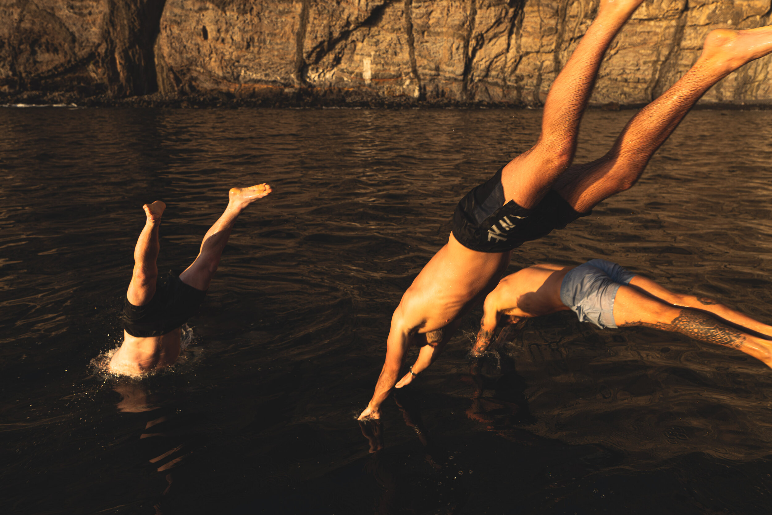 cliff jumping into water golden hour adventure lifestyle photographer london