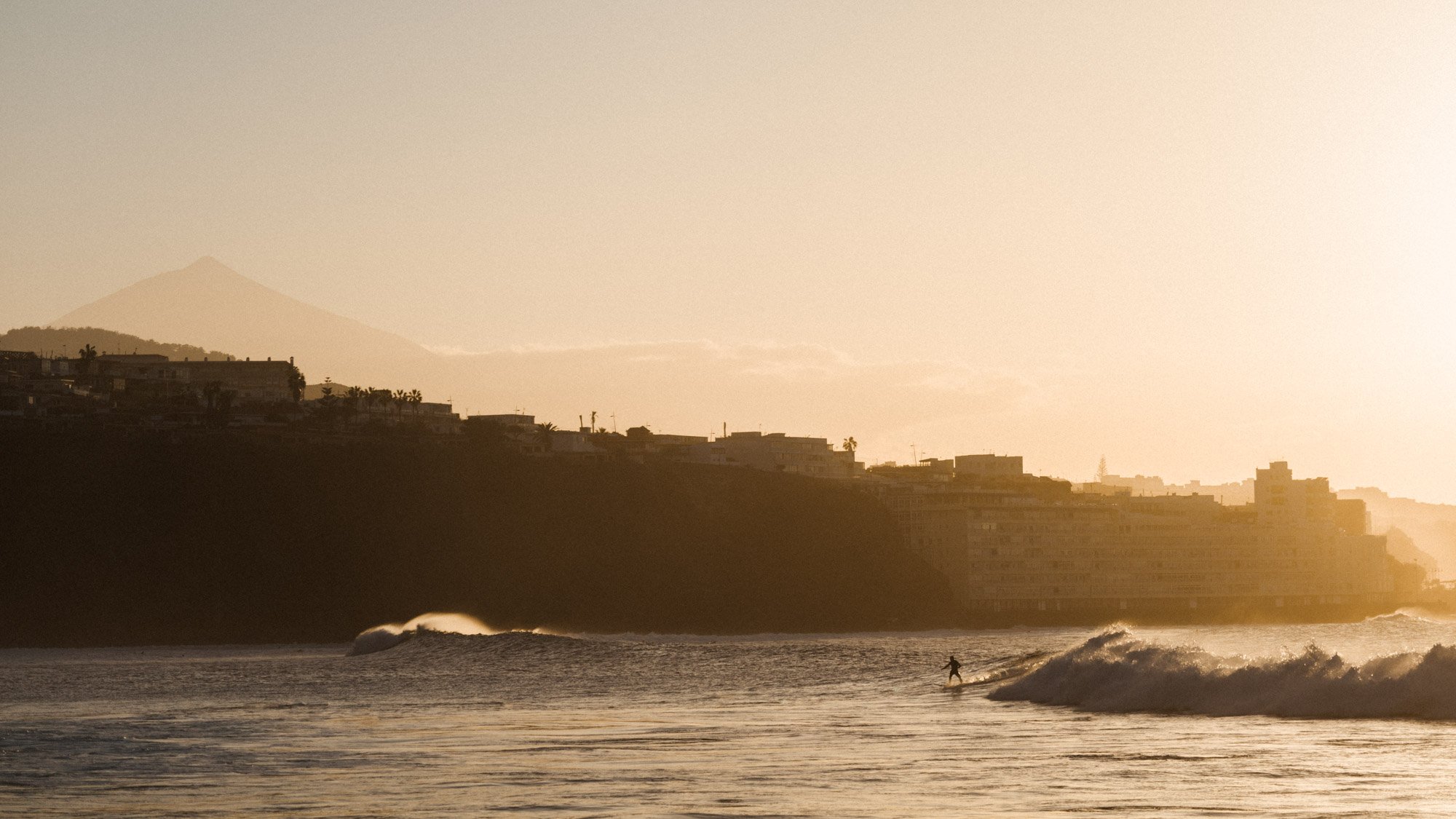 surfer wave tenerife coastal town mountain background lifestyle photographer london