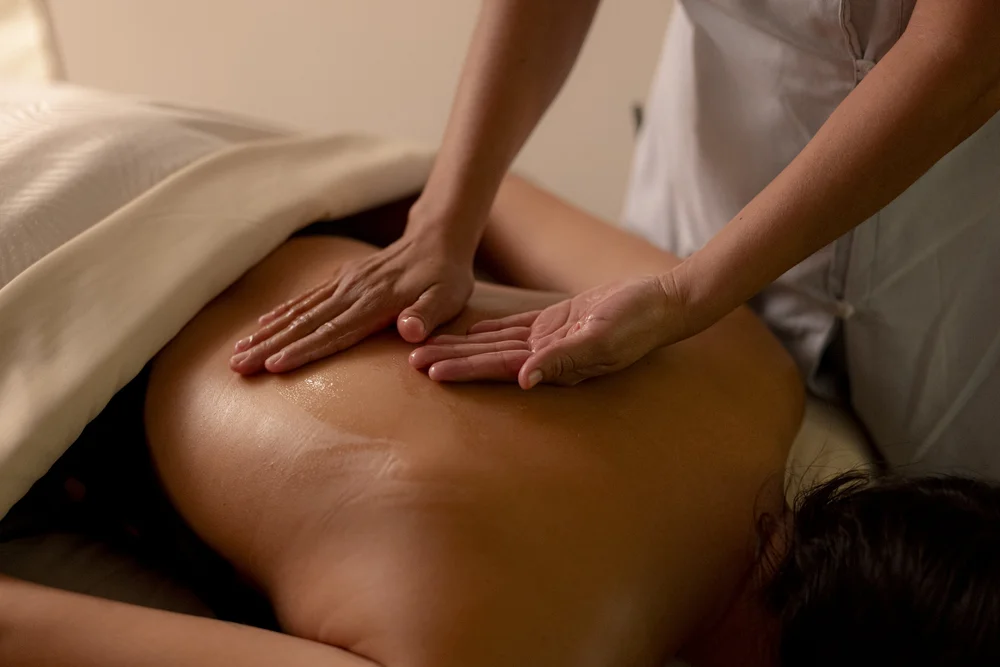 Spa therapist deep tissue back massage treatment table